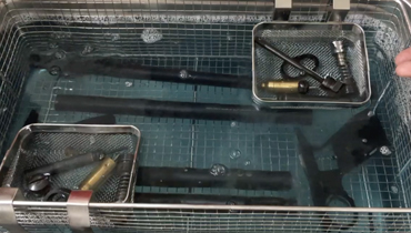 Ultrasonic cleaning for guns